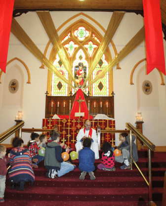 Pastor and children during children's address